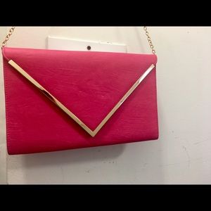 Fuscia clutch with gold trim and gold chain